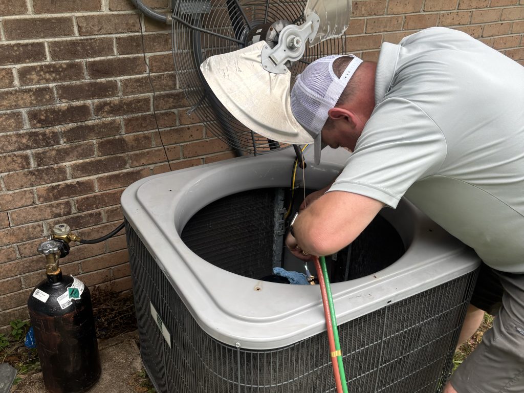 HVAC technician checking an AC running but not cooling in Mobile AL