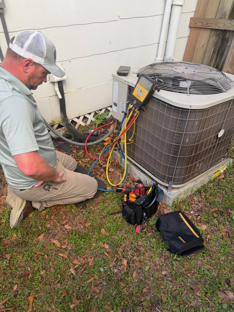 Magnolia Air Solutions technician servicing an outdoor HVAC unit